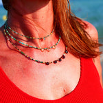 Collier DEEPTI Ginandger porté au bord de la mer en superposition - turquoises et citrines, look été
